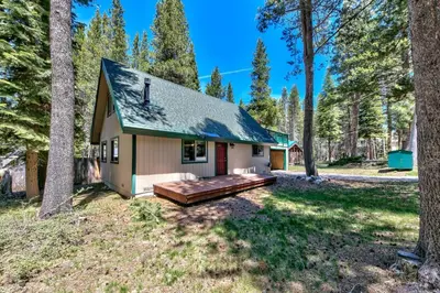 a tiny house in the woods with a porch at 1207S Cabin in the Pines in South Lake Tahoe