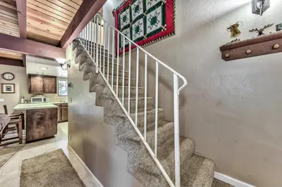 a spiral staircase in a home with a kitchen at 1207S Cabin in the Pines in South Lake Tahoe