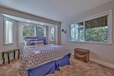 a bedroom with a bed and two windows at 122G Where Eagles Fly in South Lake Tahoe