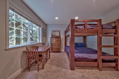 a bedroom with bunk beds and a table and a desk at 122G Where Eagles Fly in South Lake Tahoe