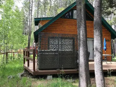 a log cabin in the woods with trees at 1625A Atroari Chalet in South Lake Tahoe