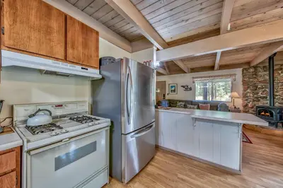 a kitchen with a stainless steel refrigerator and a stove at 1625A Atroari Chalet in South Lake Tahoe
