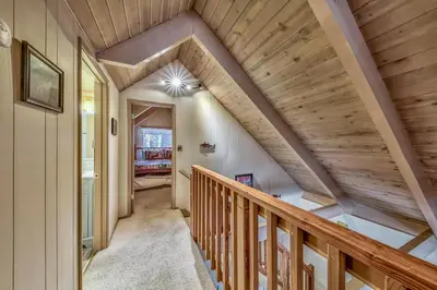 a staircase in a house with wooden ceilings at 1625A Atroari Chalet in South Lake Tahoe