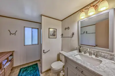 a bathroom with a sink and a toilet and a mirror at 1625A Atroari Chalet in South Lake Tahoe