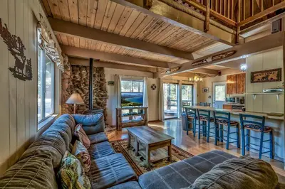 a living room with a couch and a table at 1625A Atroari Chalet in South Lake Tahoe