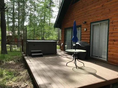 a wooden deck with a table and an umbrella at 1625A Atroari Chalet in South Lake Tahoe