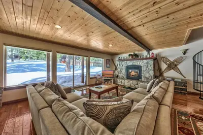 a living room with a couch and a fireplace at Tall Pines in South Lake Tahoe