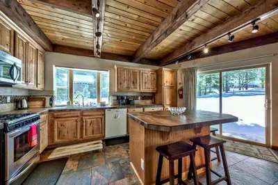 a kitchen with wooden cabinets and a wooden ceiling at Tall Pines in South Lake Tahoe