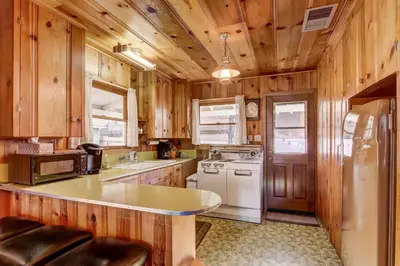 a kitchen with wooden cabinets and a white refrigerator at 3993C Cedar Cabin Lake Tahoe in South Lake Tahoe