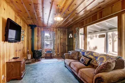 a living room with a couch and a flat screen tv at 3993C Cedar Cabin Lake Tahoe in South Lake Tahoe