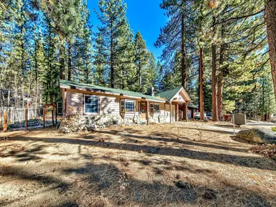 a log cabin in the woods with trees at 2556H Lazy Bear's Den in South Lake Tahoe