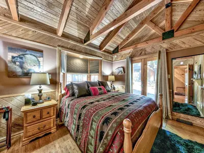 a bedroom with a large bed and a wooden ceiling at 2556H Lazy Bear's Den in South Lake Tahoe