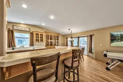 a kitchen with a large island with bar stools at 1213GB Golden Bear Tahoe Home in South Lake Tahoe