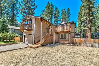 a house with a deck and a fence at 1213GB Golden Bear Tahoe Home in South Lake Tahoe