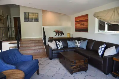 a living room with a black couch and a blue chair at 2375S Sierra house Retreat in South Lake Tahoe