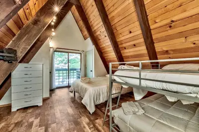 two bunk beds in a room with wooden ceilings at 3001R Reindeer A Frame Cabin in South Lake Tahoe