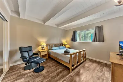 a bedroom with a bed and a desk and a chair at 2782B Tahoe River Chalet in South Lake Tahoe