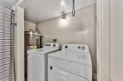 a white laundry room with a washer and dryer at 2782B Tahoe River Chalet in South Lake Tahoe