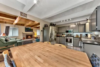 a kitchen with a large wooden table in a room at 2782B Tahoe River Chalet in South Lake Tahoe