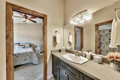 a bathroom with a sink and a mirror and a bed at Mountain View Retreat 1008C in South Lake Tahoe