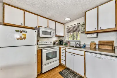 a kitchen with white appliances and wooden cabinets at 920 Bal Bijou in South Lake Tahoe