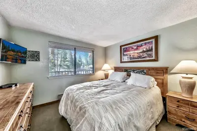 a bedroom with a bed and a desk and a window at 920 Bal Bijou in South Lake Tahoe
