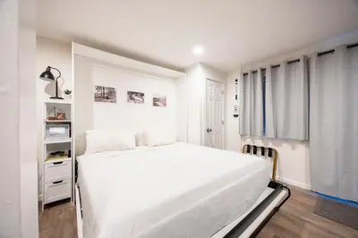 a white bedroom with a white bed and a window at Stunning Deluxe King Studio #124 at Donner Lake Village in Truckee