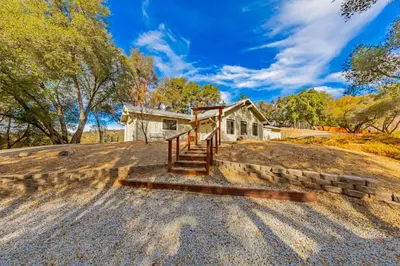 a home on a hill with a house at Yosemite Wooded Hills, Pool Table, Fitness, Views in Oakhurst