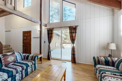 a living room with two couches and a table at Less Than 2 Mi to Tahoe Donner Ski Resort Serene Retreat in Armstrong
