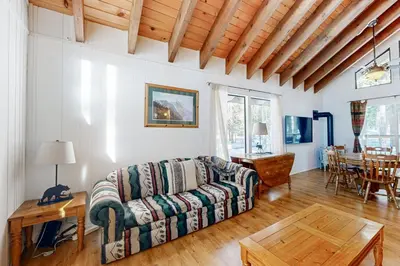 a living room with a couch and a table at Less Than 2 Mi to Tahoe Donner Ski Resort Serene Retreat in Armstrong