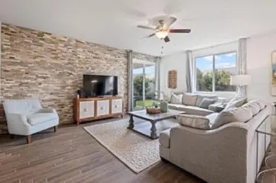 a living room with a couch and a tv at Casita Tulare in Tulare