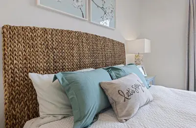 a bed with a large headboard and pillows on it at Casita Tulare in Tulare