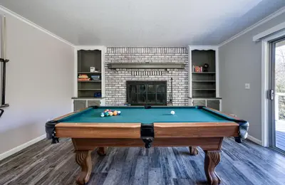 a pool table in a living room with a fireplace at Mariposa home, Yosemite retreat, deer watching, family friendly in Mariposa