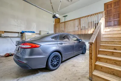 a silver car parked in a garage next to a staircase at Mariposa home, Yosemite retreat, deer watching, family friendly in Mariposa