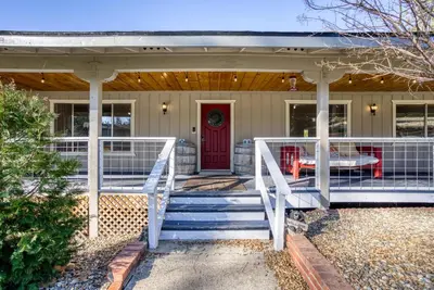 a front porch of a house with a red door at Mariposa home, Yosemite retreat, deer watching, family friendly in Mariposa