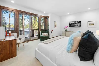 a bedroom with a large bed and a desk and chair at Luxurious Truckee Rental Hot Tub and Valley Views in Truckee