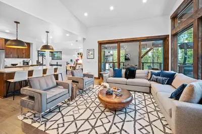 a living room with a couch and chairs and a kitchen at Luxurious Truckee Rental Hot Tub and Valley Views in Truckee