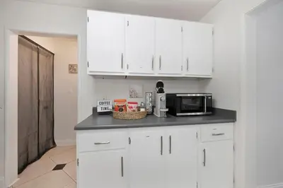 a kitchen with white cabinets and a microwave at Arden Calexpo HotTub Pool Firepit BBQ NoPetFee in Sacramento