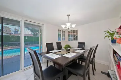 a dining room with a table and chairs and a pool at Arden Calexpo HotTub Pool Firepit BBQ NoPetFee in Sacramento