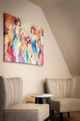 a painting hanging on a wall with two chairs and a table at Miztec Mountain - Ping pong & basketball hoop game in South Lake Tahoe