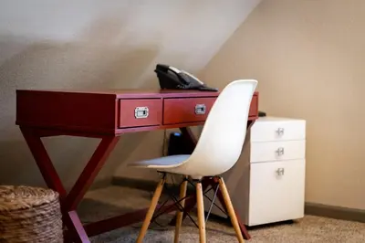 a red desk with a white chair and a telephone at Miztec Mountain - Ping pong & basketball hoop game in South Lake Tahoe