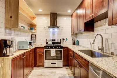 a kitchen with wooden cabinets and a stove top oven at Miztec Mountain - Ping pong & basketball hoop game in South Lake Tahoe