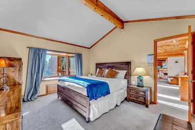 a bedroom with a bed and a window at Spacious Tahoe City Home with Foosball and Lake Views in Tahoe City