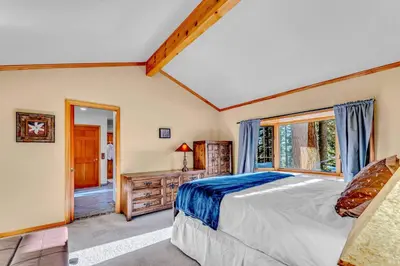 a bedroom with a large bed and a window at Spacious Tahoe City Home with Foosball and Lake Views in Tahoe City