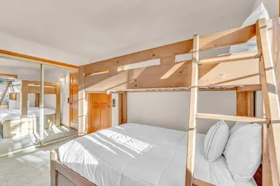 a bedroom with two bunk beds in a house at Spacious Tahoe City Home with Foosball and Lake Views in Tahoe City