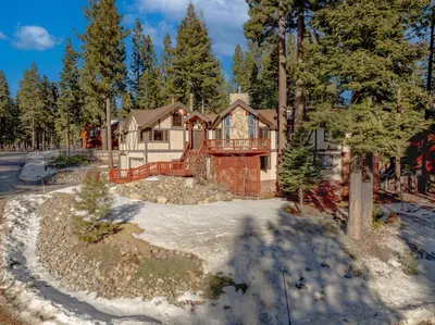 a house in the woods with snow on the ground at Spacious Tahoe City Home with Foosball and Lake Views in Tahoe City