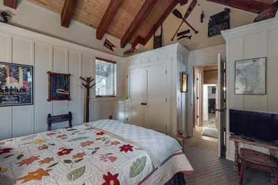 a bedroom with a bed and a tv in it at Lakefront Luxury in Tahoe City