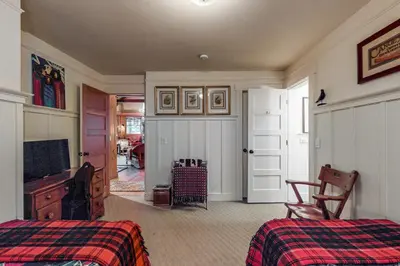 a bedroom with two beds and a flat screen tv at Lakefront Luxury in Tahoe City