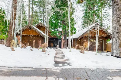 a log cabin in the woods in the snow at Lakefront Luxury in Tahoe City