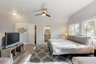 a bedroom with a bed and a flat screen tv at Serendipity in Groveland